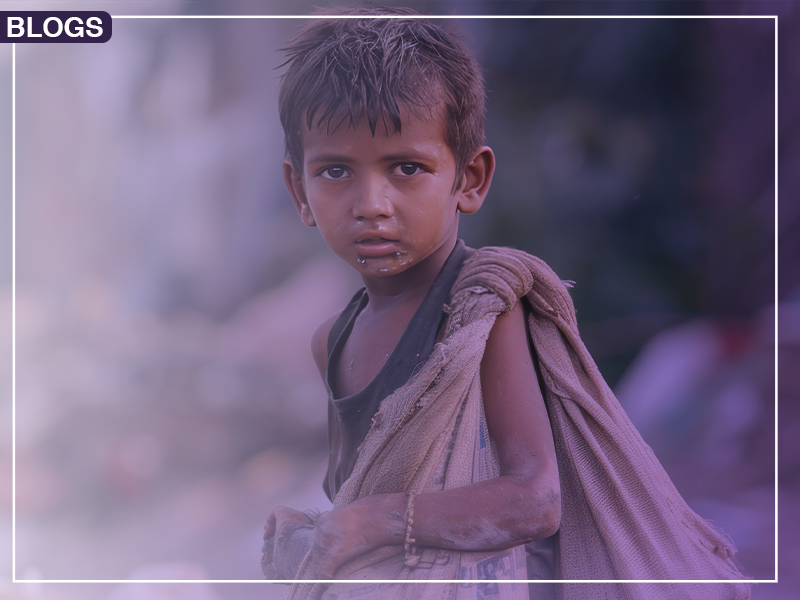 A young child wearing a tattered shirt and carrying a large sack over one shoulder, standing in an outdoor setting.

The support for humanity is writing a blog on 10 Strategies to Combat Poverty & Boost Education Access