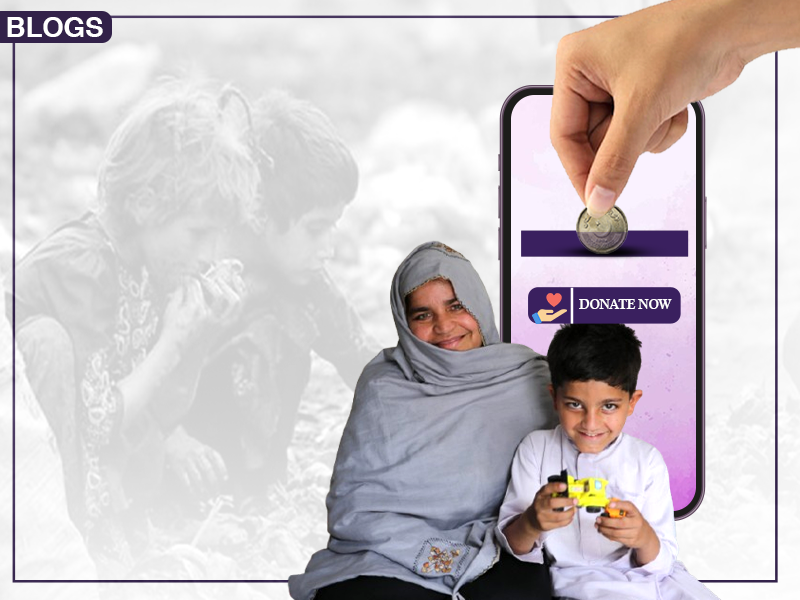 A promotional image for a charity organization, featuring a woman and a child sitting together. The child is holding a toy. In the background, there is a faded image of two children. On the right side, a hand is shown inserting a coin into a slot on a smartphone screen with a "Donate Now" button below it.